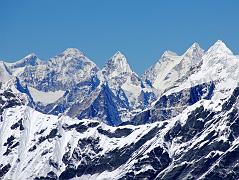 
From the top of the West Col (6135m), the view to the northwest included the east face of Gauri Shankar, the triangular summit of Drangnag Ri, the saddle connecting the Menlungtse West and East summits, and Taweche to the right.
